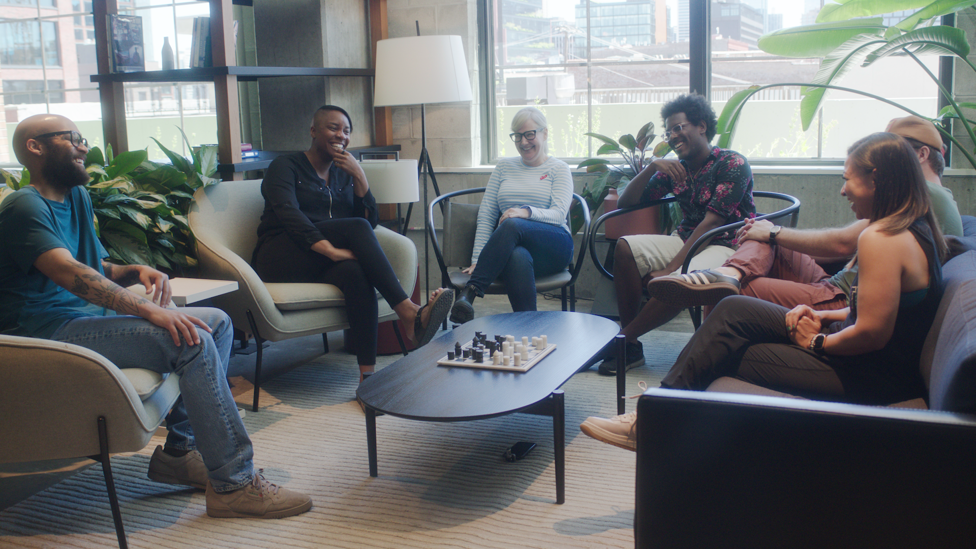 Group of people sitting in chairs laughing