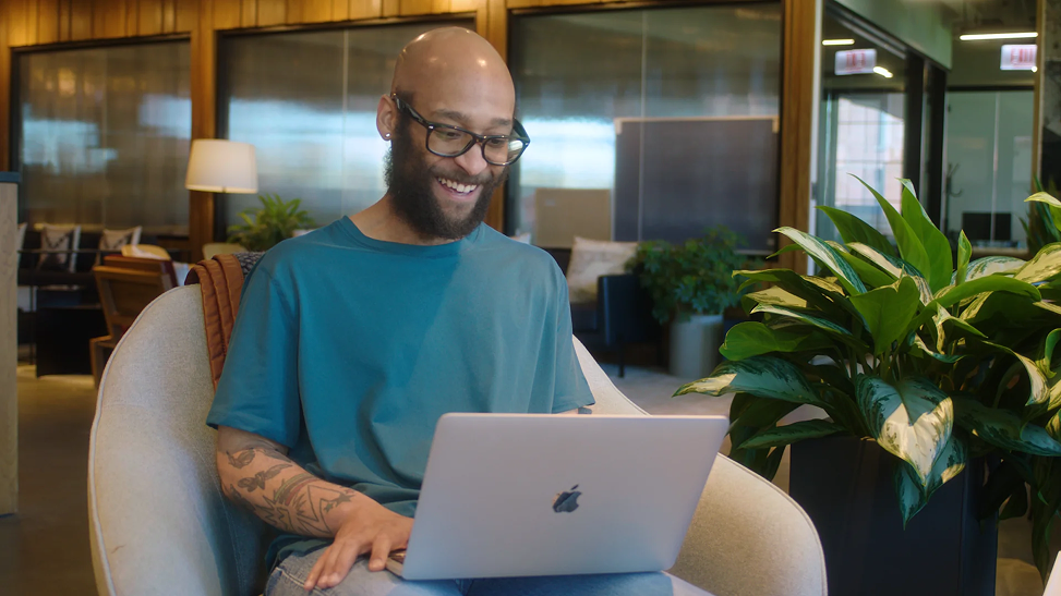 person on a laptop smiling
